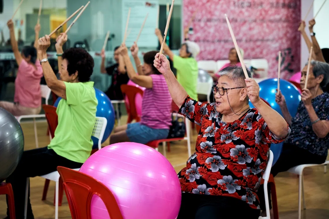 Retiree Quek Lee Hai (pictured in red) takes part in weekly exercise ball drumming sessions held at the Adventist Active Ageing Centre near her home to stay active. 