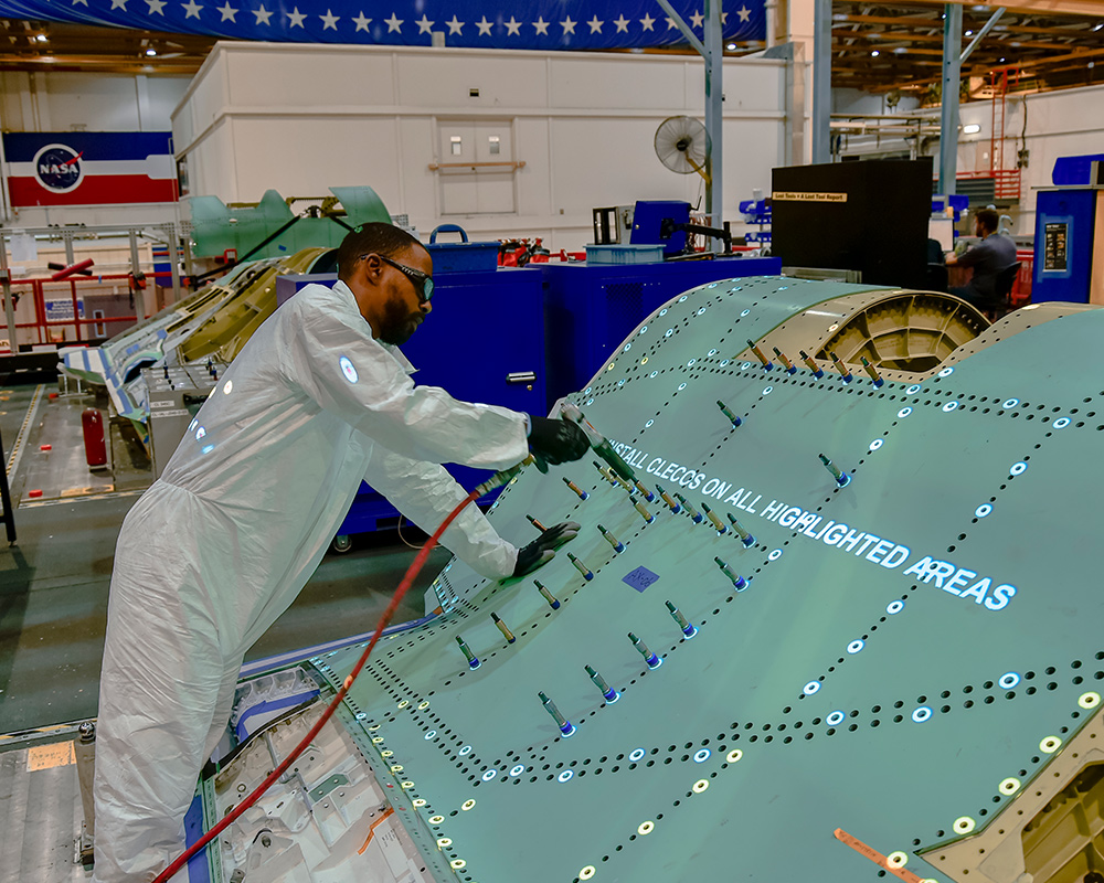 Military Aircraft man working on military aircraft in manufacturing facility