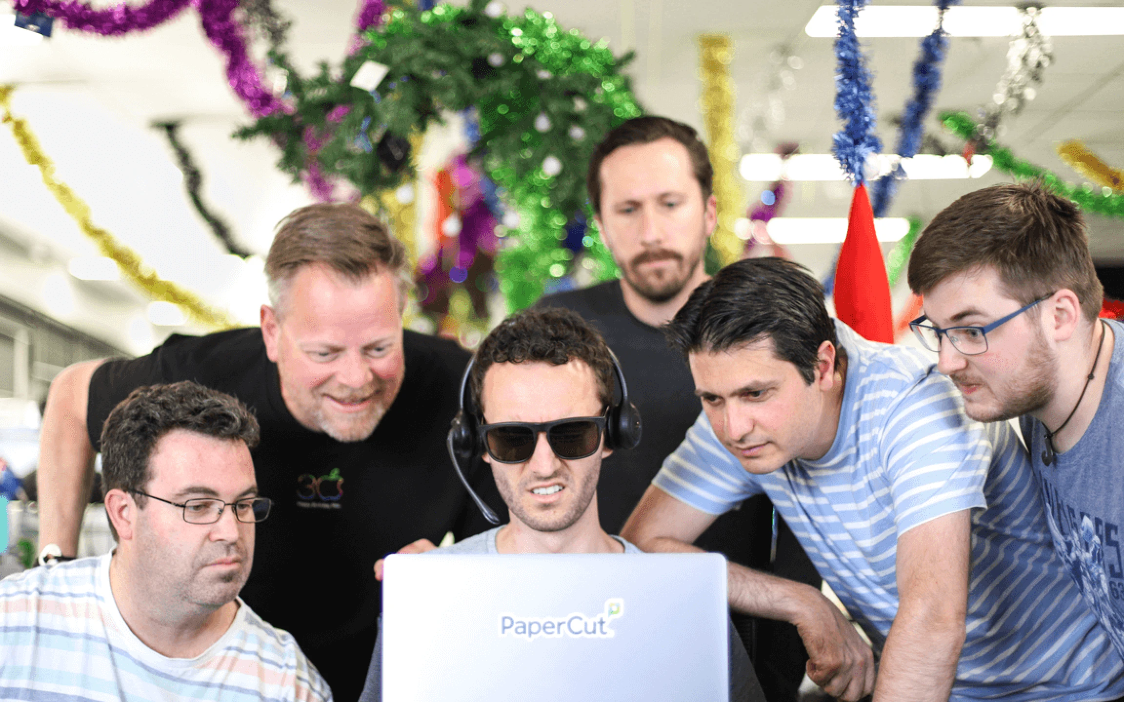 People crowding around one laptop