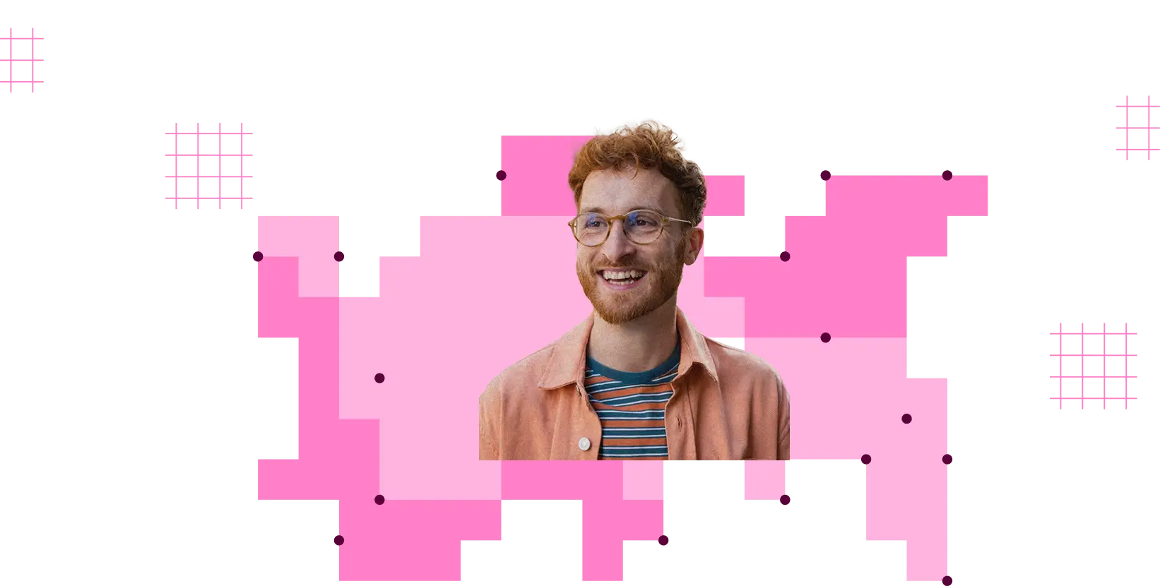 Smiling man with curly red hair and beard wearing glasses, a striped shirt, and a peach jacket with pink graphic background.