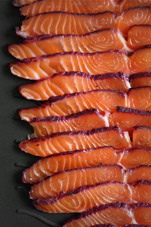 Slices of blackcurrant-cured salmon