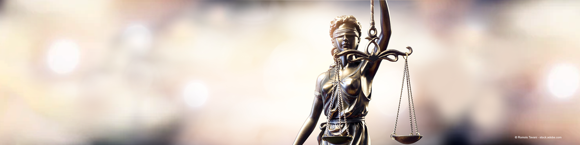 Themis or statue of Lady Justice on blurred background.