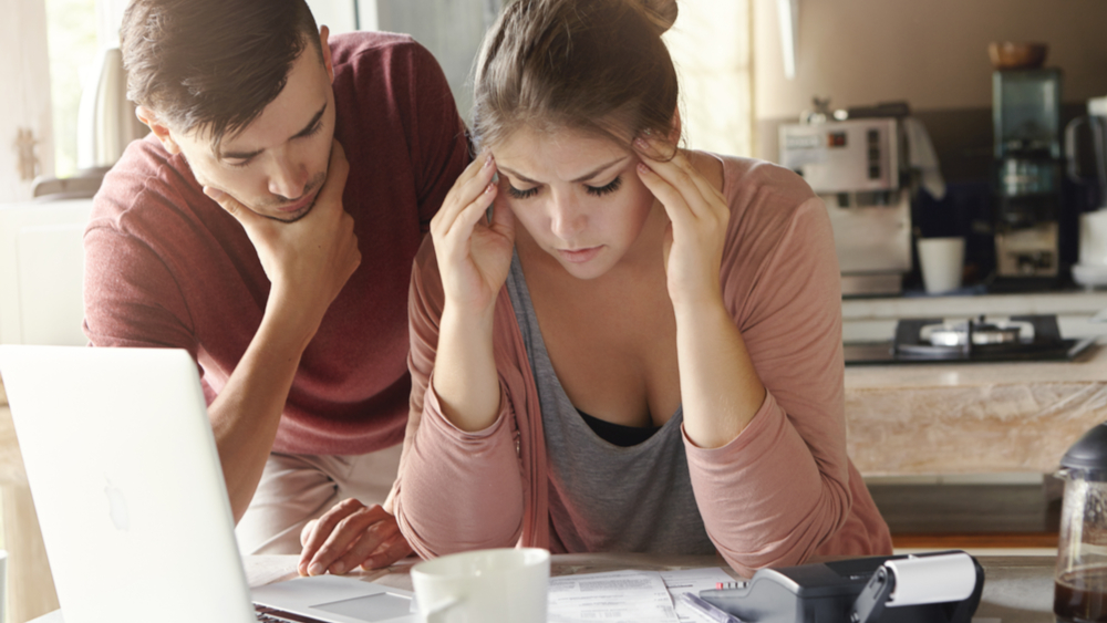 man and woman looking at some papers and looking concerned
