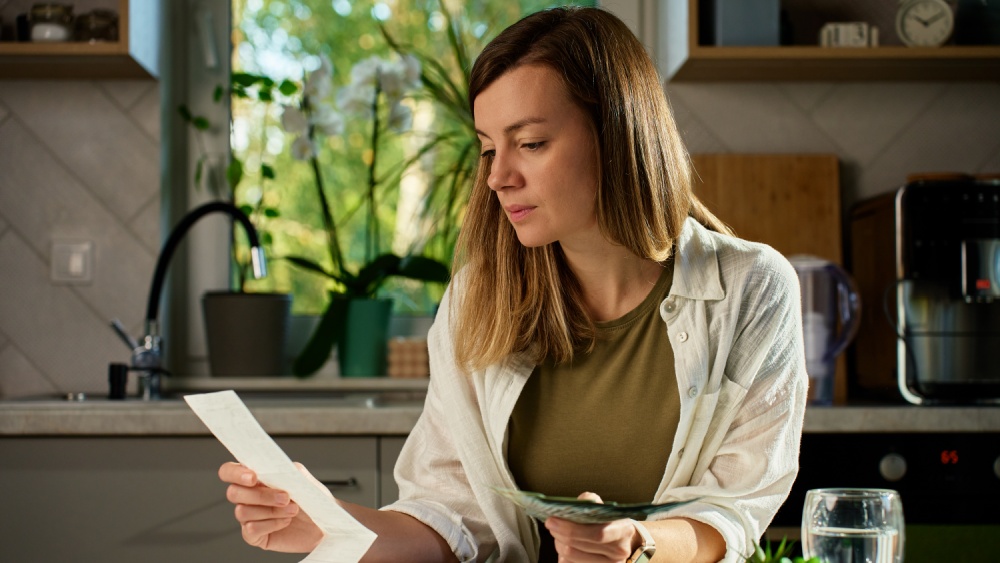 women looking at receipts at looking a bit worried