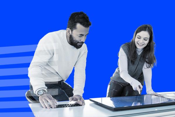 Man and woman looking at a tablet on a desk
