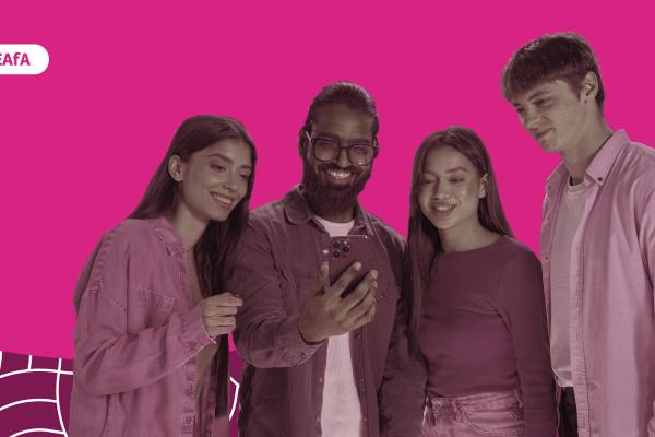 A group of young people looking at a phone