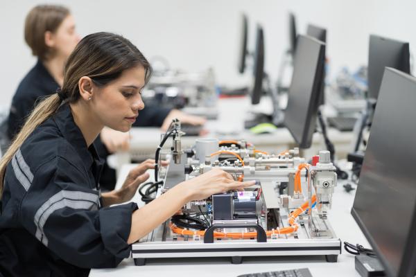 Two women working on hardware equipment