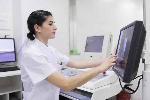 Woman nurse looking at computer screen