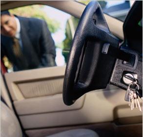 man-looking-into-car-keys-locked-in-ignition