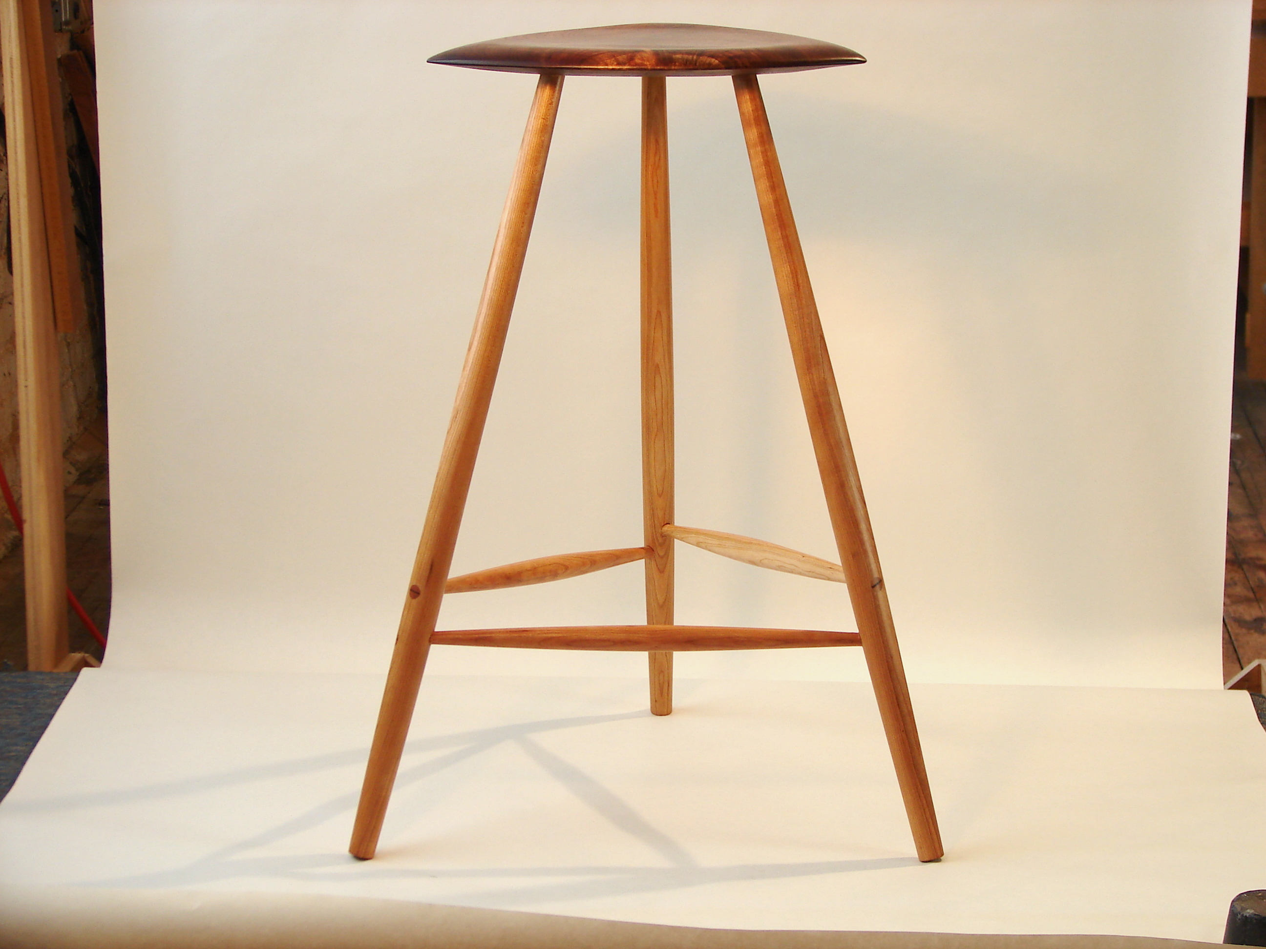Sculpted walnut 3-legged stool