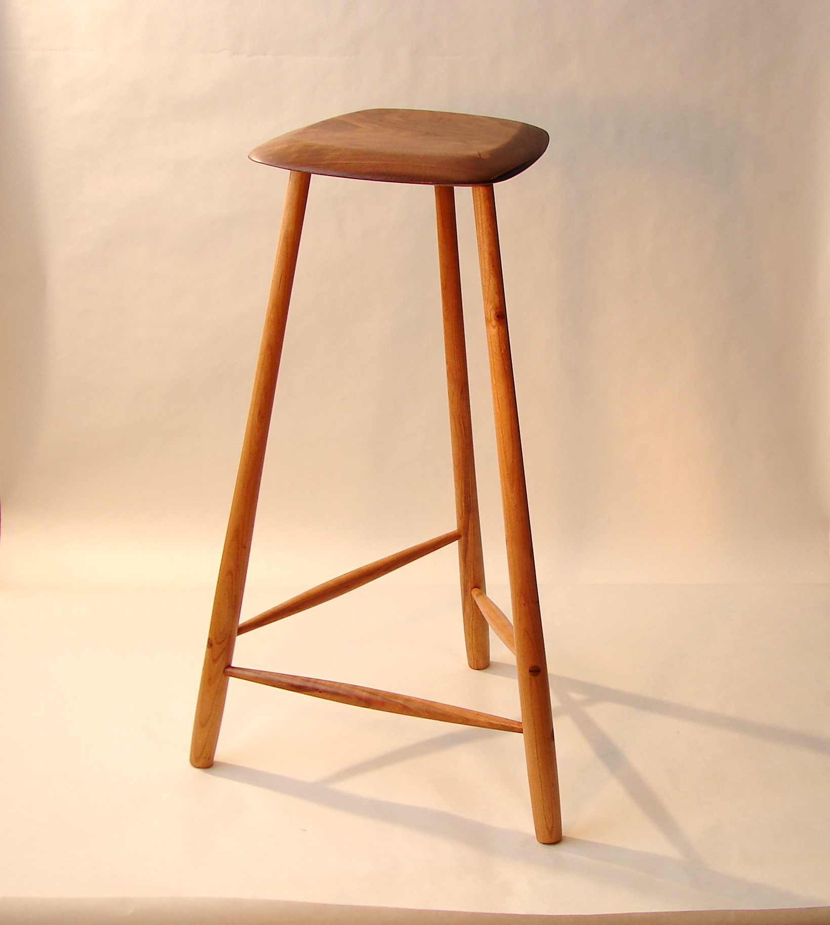Sculpted walnut 3-legged stool