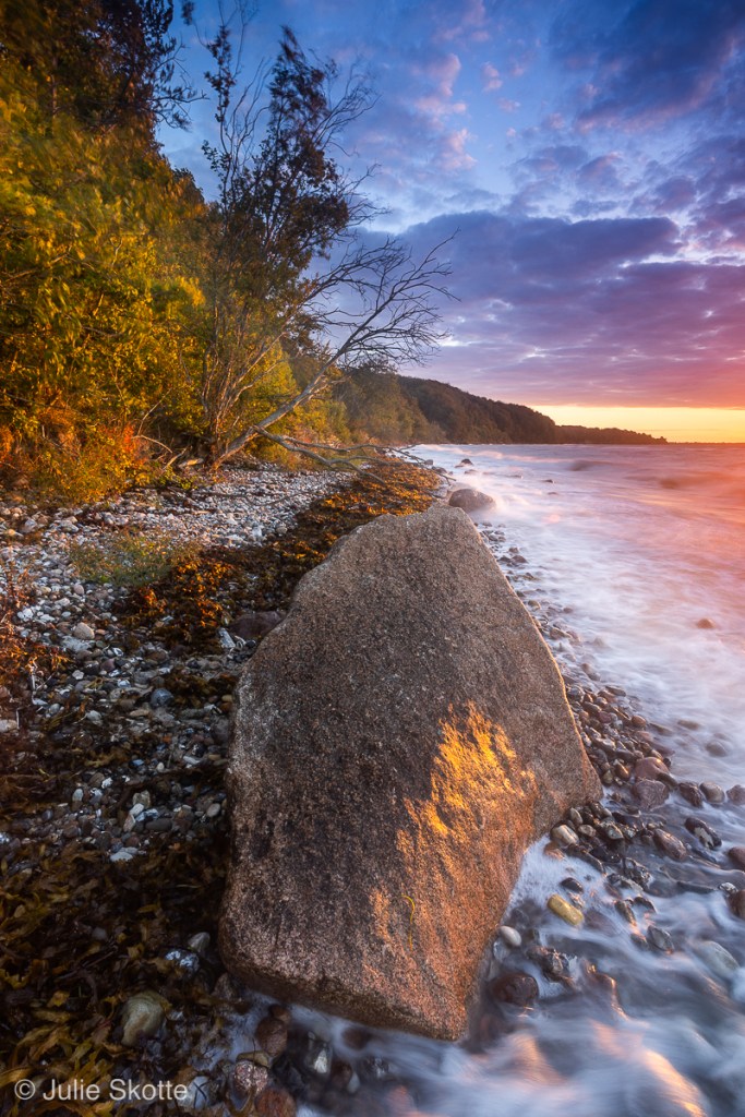 Rocks on the beach at Tormaj strand, Haderslev, Denmark at sunrise.