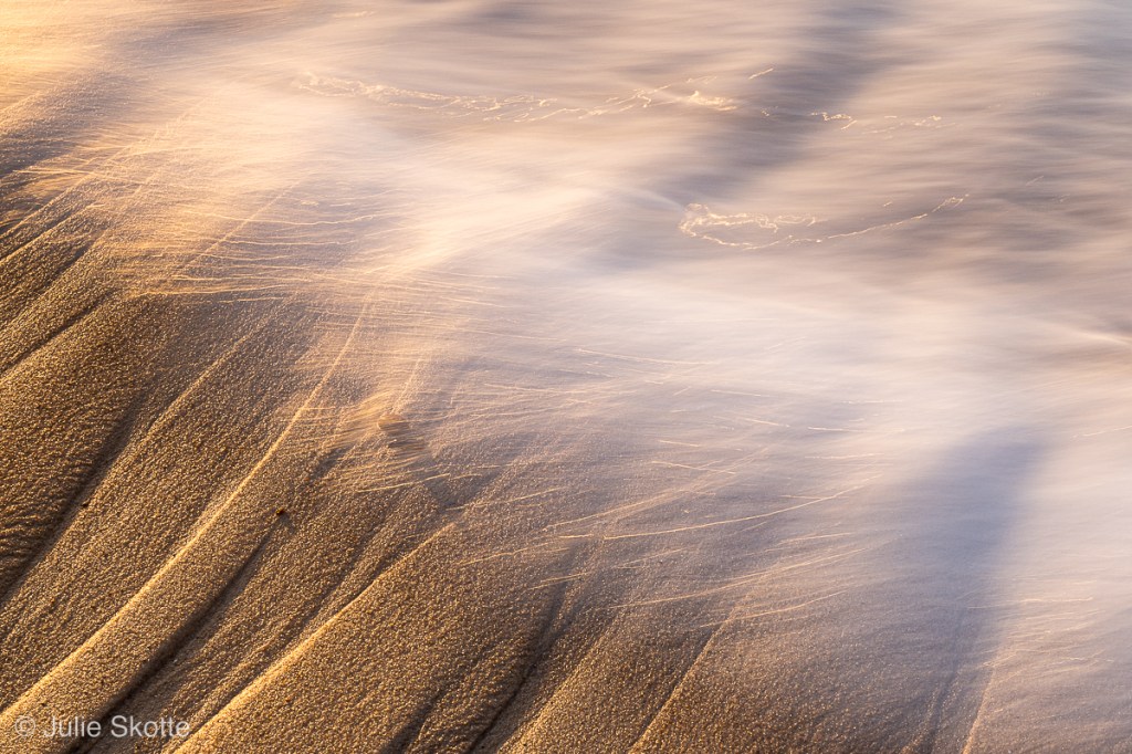 Sand patterns and white water hitting the beach