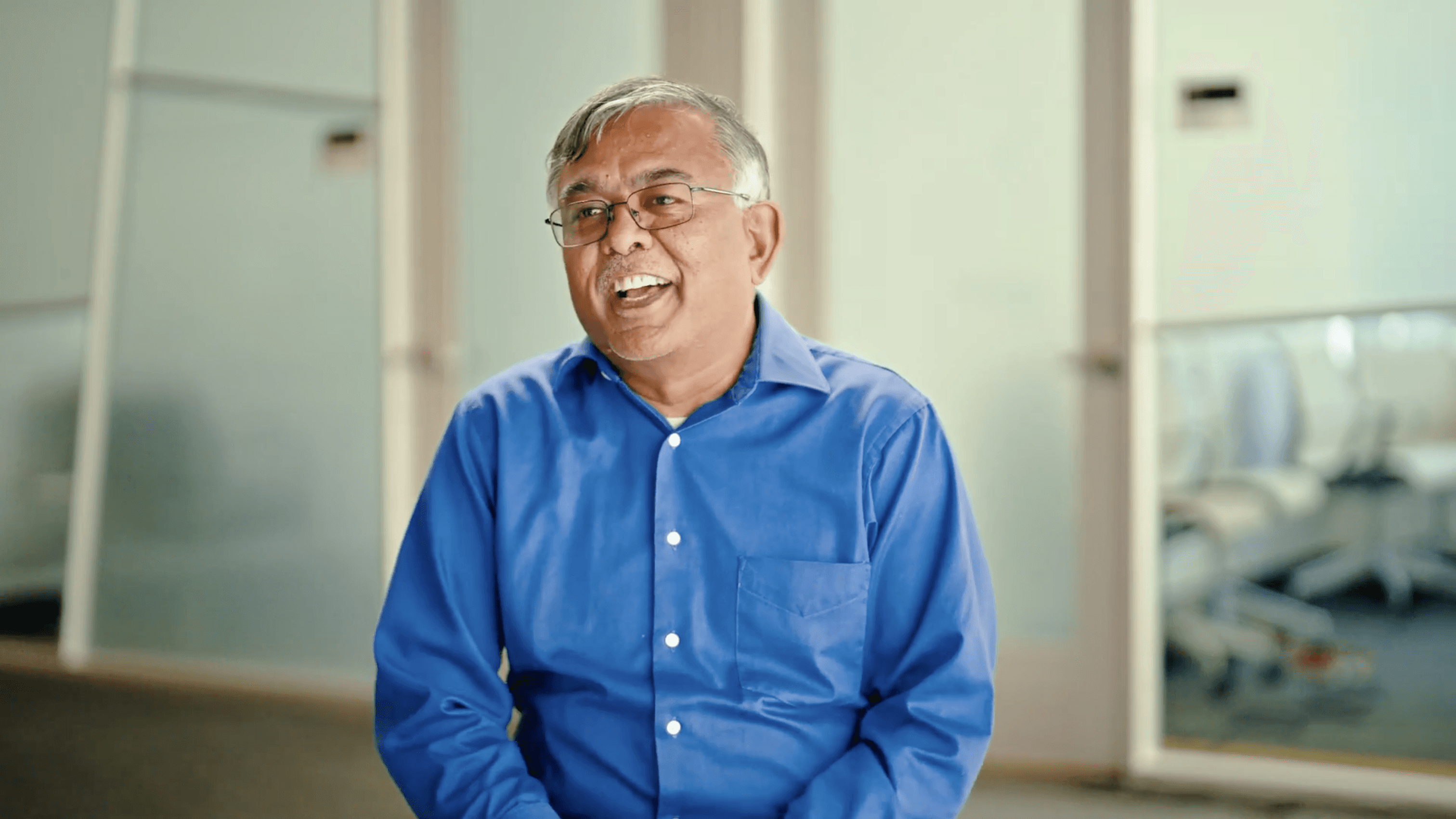 A person in a blue jacket looking at the camera.