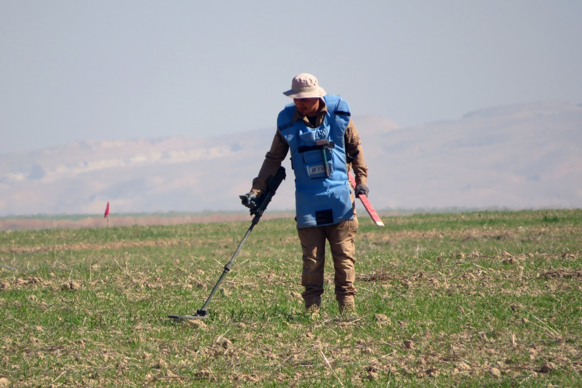 FSD deminer using a detector to inspect a field in Iraq Clearance IQ