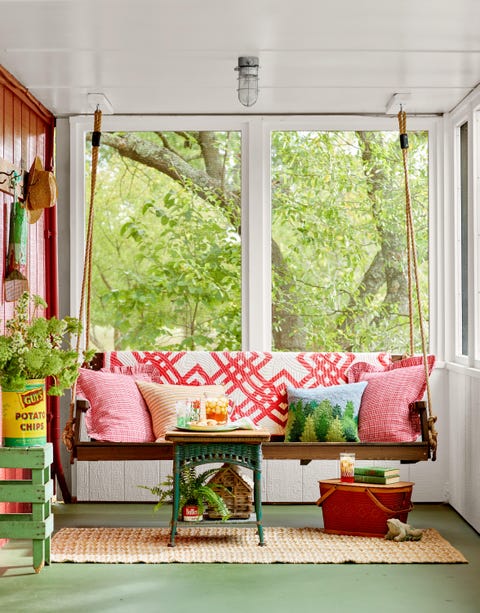 Cozy porch swing with colorful pillows and small table with drinks and snacks. Cozy porch swing with colorful pillows and small table with drinks and snacks.
