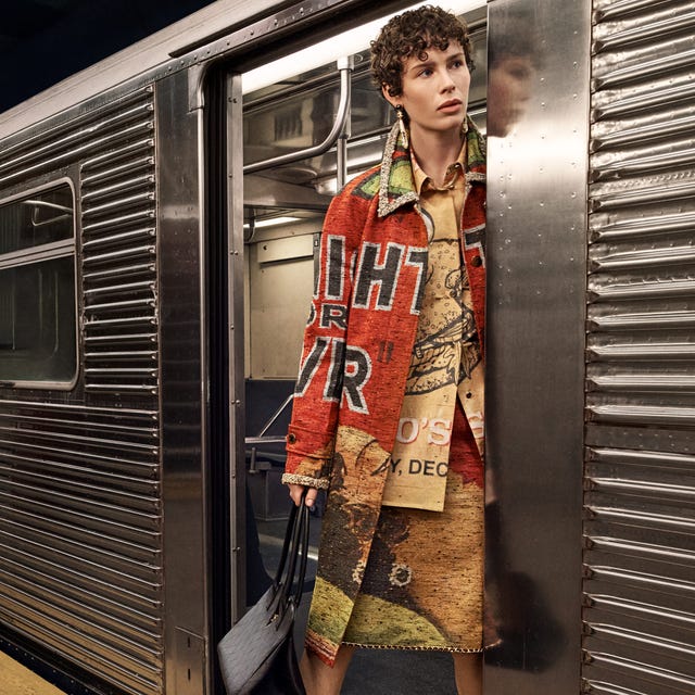 Person standing in colorful outfit holding a black bag in a subway train doorway. Person standing in colorful outfit holding a black bag in a subway train doorway.