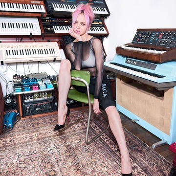 Woman sitting in front of synthesizers and electronic instruments. Woman sitting in front of synthesizers and electronic instruments.