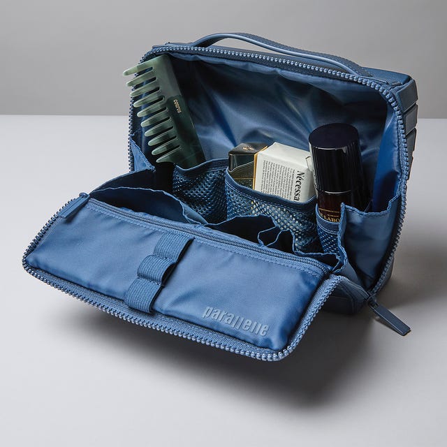 Cosmetic bag opened, displaying various beauty products. Cosmetic bag opened, displaying various beauty products.