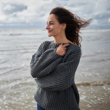 person standing on a beach with waves in the background person standing on a beach with waves in the background