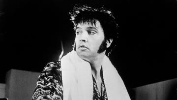 Elvis Presley takes a break from singing during his stint at Las Vegas. Elvis Presley takes a break from singing during his stint at Las Vegas.