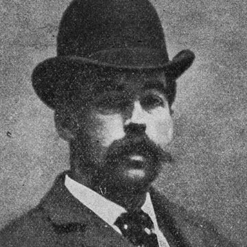 H.H. Holmes hh holmes looks at the camera, he wears a bowler hat, jacket, collared shirt and tie and has a mustache