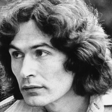 Rodney Alcala in 1980 rodney alcala looks to the left in a close up shot, he wears a collared shirt and has long flowing hair