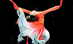 How Does Confucianism Influence Chinese Dance? Dancer dressed in red, expressing emotion and movement in her performance
