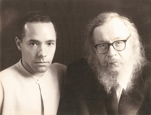 Black and white photo of Jerzy Grotowski and Thomas Richards. Richards, on the left, has short hair and is wearing a light-colored shirt, while Grotowski, on the right, has a long beard, wears glasses and is dressed in a dark suit. Black and white photo of Jerzy Grotowski and Thomas Richards. Richards, on the left, has short hair and is wearing a light-colored shirt, while Grotowski, on the right, has a long beard, wears glasses and is dressed in a dark suit.