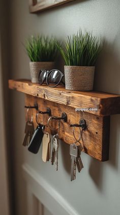 a wooden shelf with keys and plants on it