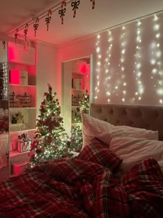 a bedroom decorated for christmas with lights on the walls and a tree in the corner