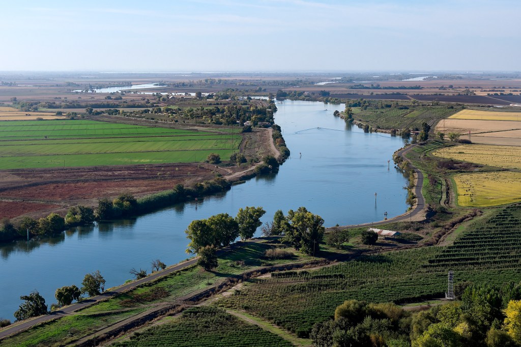 An aerial view of a river surrounded by farmland.