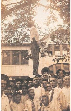 Postcard depicting the lynching of Lige Daniels, Center, Texas, USA, August 3, 1920. The back reads, "This was made in the court yard in Center, Texas. He is a 16 year old Black boy. He killed Earl's grandma. She was Florence's mother. Give this to Bud. From Aunt Myrtle."