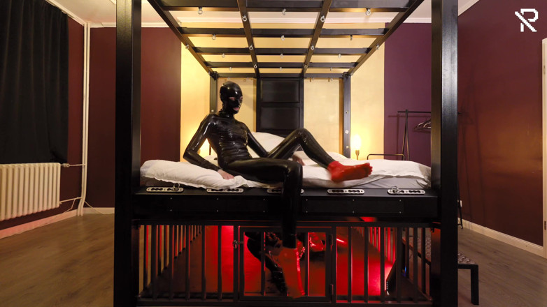Rubber pervs: Rubber Nights: the Rubber Slave Rests Tight in a Cage...