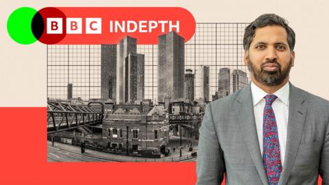 A montage image shows BBC economics editor Faisal Islam standing in front of a black-and-white image of Manchester's skyline. Islam is bearded with dark greying hair and wears a grey suit with a multicoloured tie and a white shirt. In the background is the BBC InDepth logo and a beige and a red backdrop.