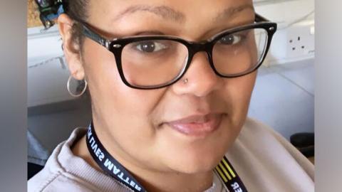 Chloe Chin-Saad with her hair tied back in a ponytail, wearing black glasses and with a lanyard round her neck.