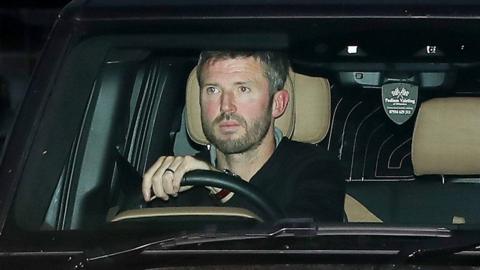 Manchester United head coach Michael Carrick leaves the club's Carrington training ground in his car