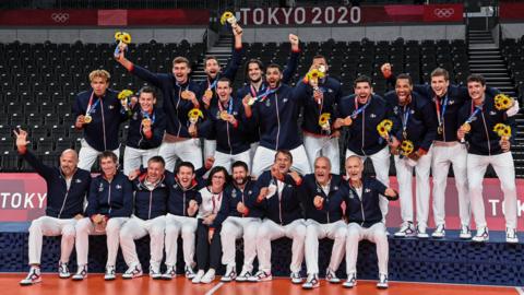 The French volleyball team are celebrating their gold medal