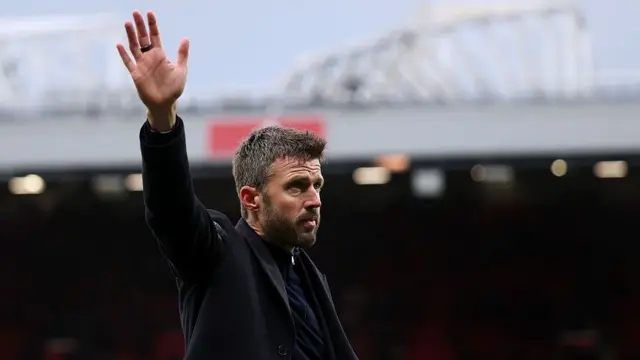 Michael Carrick, Manager of Manchester United, waves to the fans