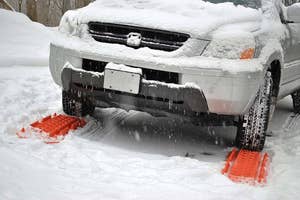 Car with traction mats in snow