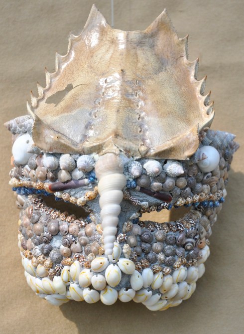 My parents brought me home a horseshoe crab shell. It makes a fragile but impressive mask.