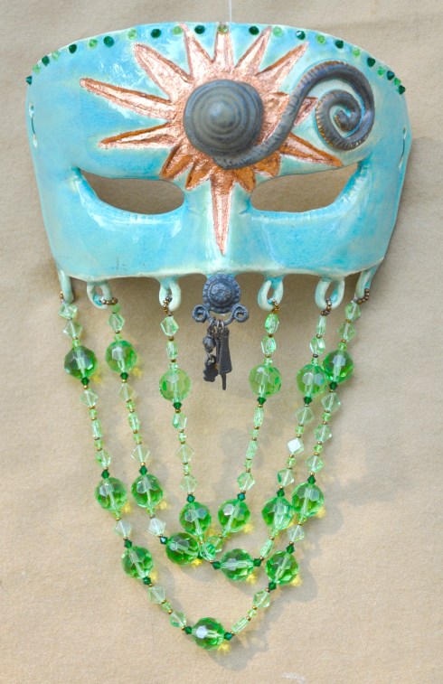 One of my favorite of my newest masks. I may have to keep her. Clay, glass and copper leaf.