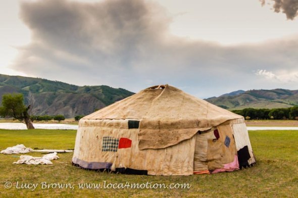 Contructing a Mongolian ger. Layers of wool felt cover the framework. Khutag Ondor, Central Mongolia Contructing a Mongolian ger. Layers of wool felt cover the framework. Khutag Ondor, Central Mongolia