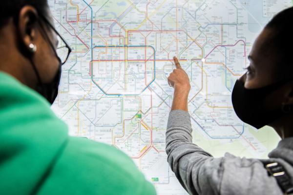 Two ladies looking at the tube map