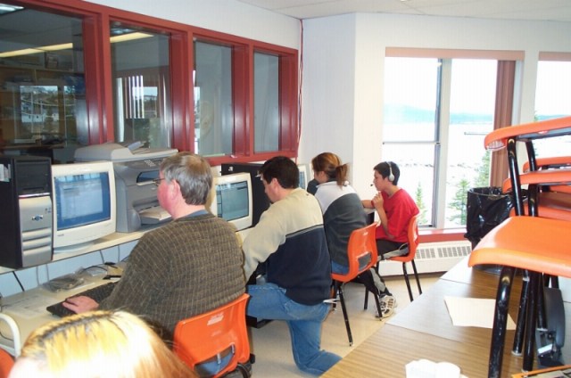 Setting up the distance education room at Northern Lights Academy. Frank and Dwayne (ICT Manager with Labrador School District) are setting up the machines. Note the extensive use of glass...