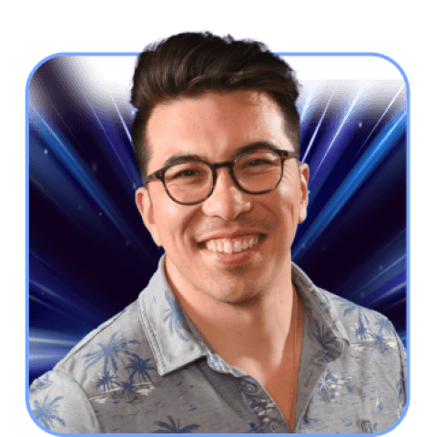 Smiling man with glasses and patterned shirt.