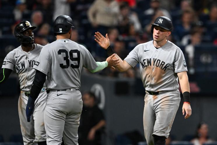 Ali Sánchez #39 and Ben Rice #22 of the New York Yankees celebrate scoring on a single hit by Cody Bellinger during the tenth inning against the Cleveland Guardians at Progressive Field on June 08, 2026 in Cleveland, Ohio.