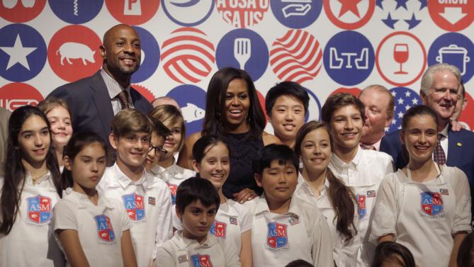 U.S. first lady Michelle Obama poses after a cooking demonstration at the James Beard American Restaurant with Italian and American middle school students in Milan, Italy, Wednesday, June 17, 2015. Michelle Obama is in Milan on the second leg of a European trip that puts an international spin on her core initiatives. (AP Photo/Antonio Calanni)