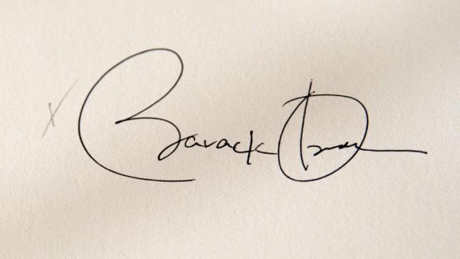 President Barack Obama's signature is seen on H.R. 1295 Trade Preferences Extension Act of 2015, Monday, June 29, 2015, in the East Room of the White Hous in Washington. The president signed into law two hard-fought bills giving him greater authority to negotiate international trade deals and providing aid to workers whose jobs are displaced by such pacts (AP Photo/Carolyn Kaster)