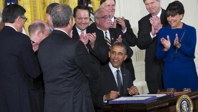 President Barack Obama smiles after signing ceremony for H.R. 2146 Defending Public Safety Employees Retirement Act and H.R. 1295 Trade Preferences Extension Act of 2015, Monday, June 29, 2015, in the East Room of the White House in Washington. The president signed into law two hard-fought bills giving him greater authority to negotiate international trade deals and providing aid to workers whose jobs are displaced by such pacts. (AP Photo/Evan Vucci)